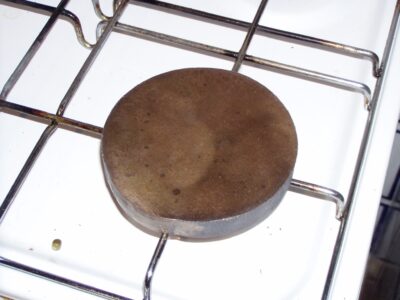 Iron disk positioned over the burning flame